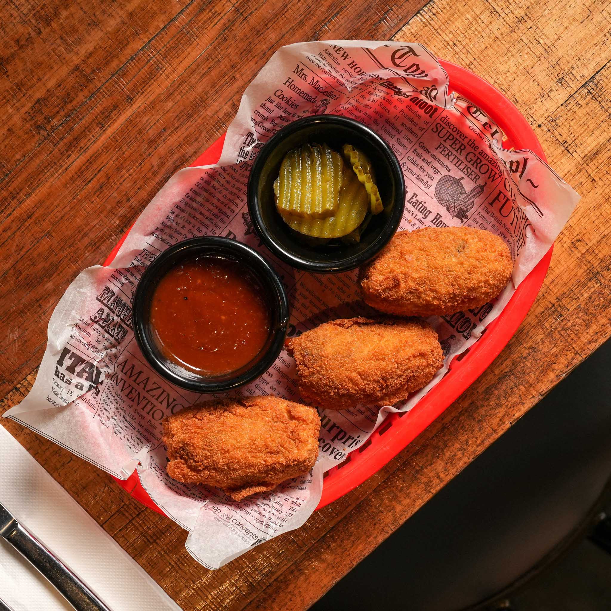 Brisket & Jalapeño Croquettes | Slow-Smoked Brisket, Jalapeño And Cheese Croquettes, Served With House BBQ Glaze And Pickles | $18.80