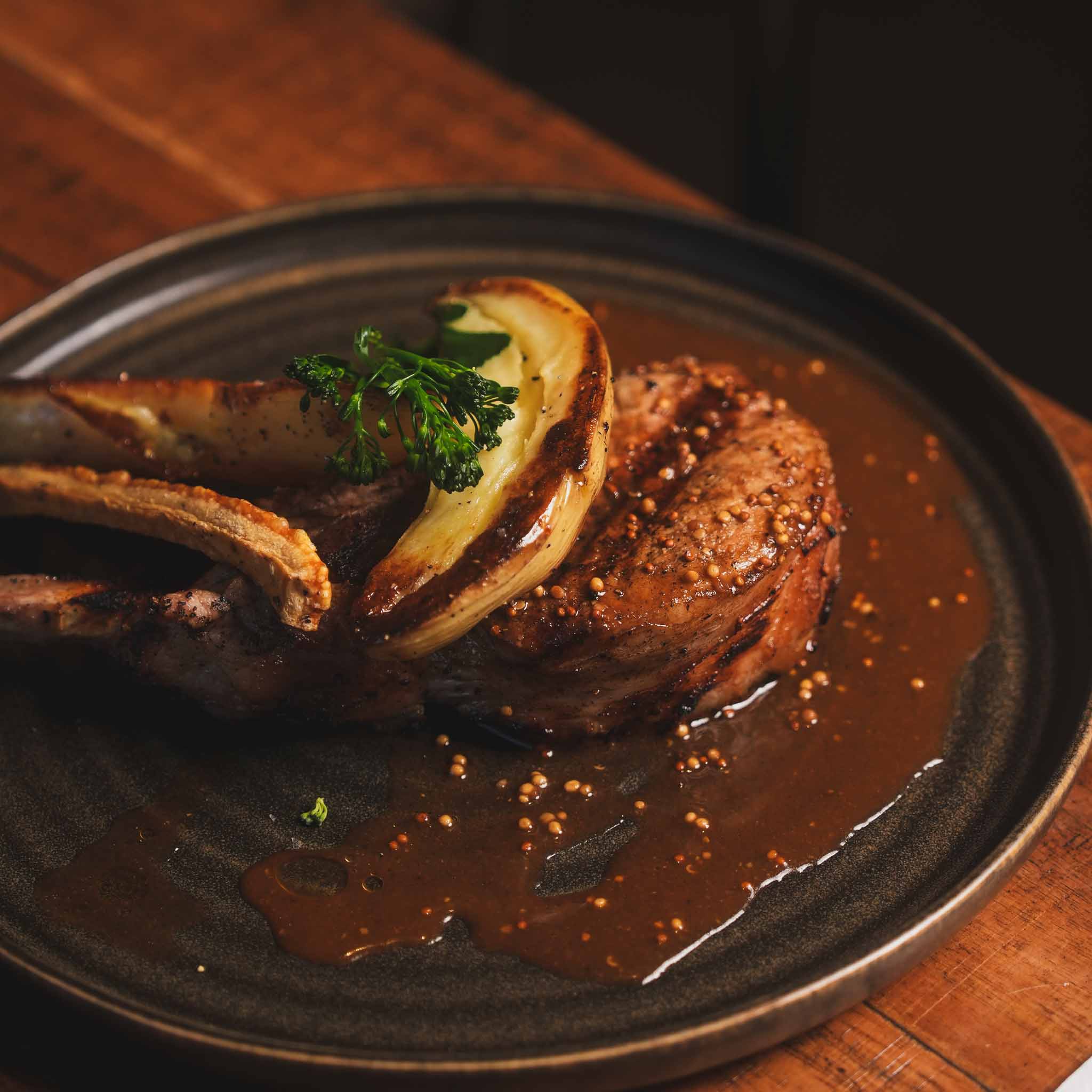 Char-Grilled King Henry Pork Chop | A 250g Char-Grilled King Henry Pork Chop Served With Roasted Kipfler Potatoes, Broccolini And Rich Mustard Jus | $31.80