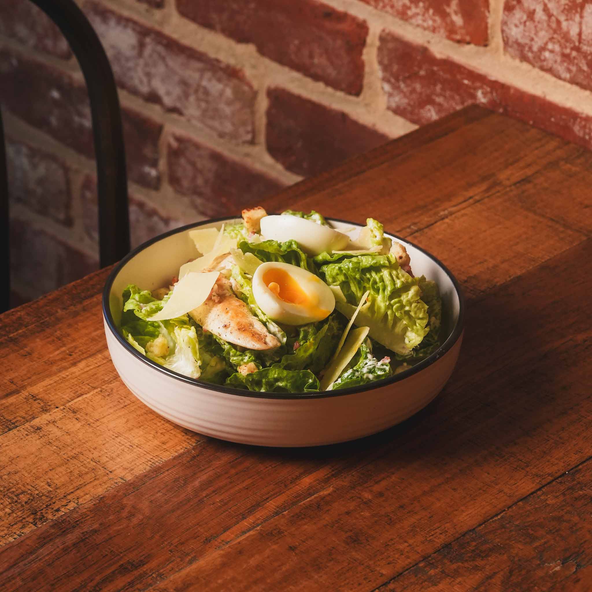Grilled Chicken Caesar Salad | Grilled Chicken, Crispy Bacon, Crunchy Croutons, Soft-Boiled Egg And Parmesan Over Cos Lettuce With Classic Caesar Dressing | $28.80